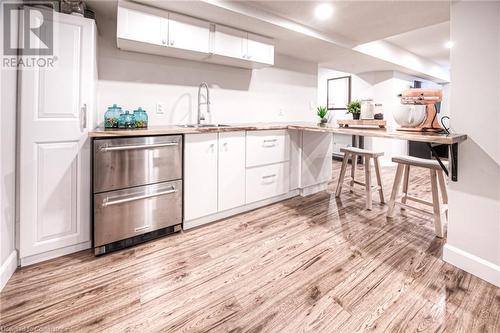 Kitchen featuring white cabinetry, sink, and light hardwood / wood-style flooring - 66 Lock Street, Innerkip, ON - Indoor