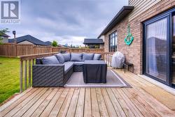 Wooden terrace featuring area for grilling and an outdoor living space - 