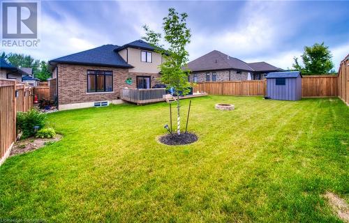 View of yard with a storage shed and an outdoor fire pit - 66 Lock Street, Innerkip, ON - Outdoor With Backyard