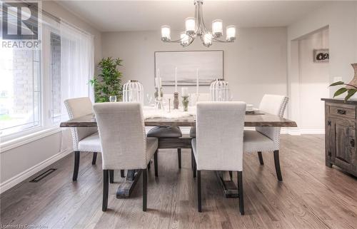 Dining area with hardwood / wood-style flooring and a notable chandelier - 66 Lock Street, Innerkip, ON - Indoor Photo Showing Dining Room