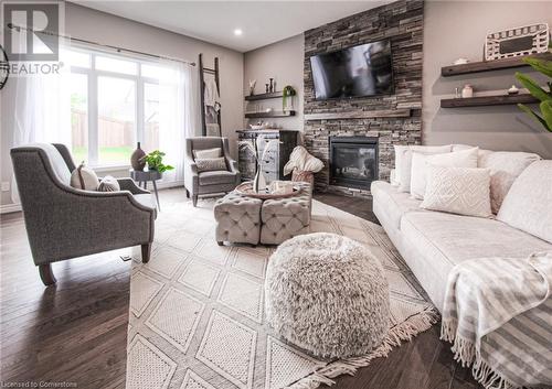 Living room with a fireplace and hardwood / wood-style flooring - 66 Lock Street, Innerkip, ON - Indoor Photo Showing Living Room With Fireplace