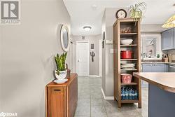 Hall featuring sink and light tile patterned floors - 