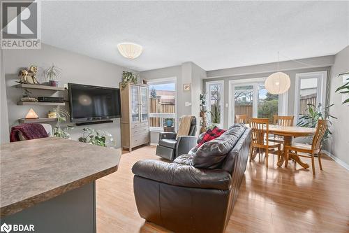 Living room featuring light wood-type flooring and a textured ceiling - 17 Emslie Street, Halton, ON - Indoor Photo Showing Living Room