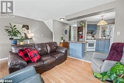 Living room featuring light hardwood / wood-style floors and sink - 