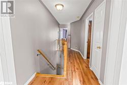 Hallway featuring a textured ceiling and light hardwood / wood-style floors - 