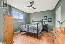 Bedroom with ceiling fan and light wood-type flooring - 