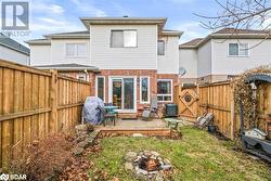 Rear view of property with central air condition unit, an outdoor fire pit, and a wooden deck - 