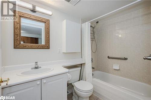 Full bathroom featuring vanity, toilet, and shower / bath combo with shower curtain - 2300 Parkhaven Boulevard Unit# 103, Oakville, ON - Indoor Photo Showing Bathroom