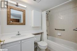 Full bathroom featuring vanity, toilet, and shower / bath combo with shower curtain - 