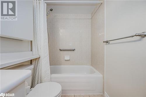 Full bathroom featuring shower / bathtub combination with curtain, tile patterned flooring, vanity, and toilet - 2300 Parkhaven Boulevard Unit# 103, Oakville, ON - Indoor Photo Showing Bathroom