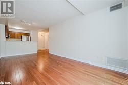 Unfurnished living room with a textured ceiling and light hardwood / wood-style flooring - 