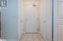 Entryway with light tile patterned floors - 