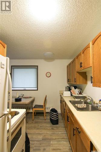 144 First Avenue N, Yorkton, SK - Indoor Photo Showing Kitchen With Double Sink