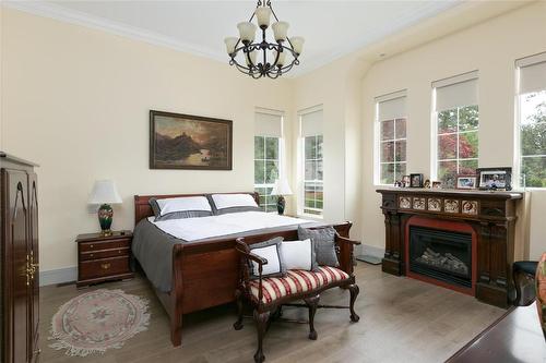 21-1150 Mission Ridge Road, Kelowna, BC - Indoor Photo Showing Bedroom With Fireplace