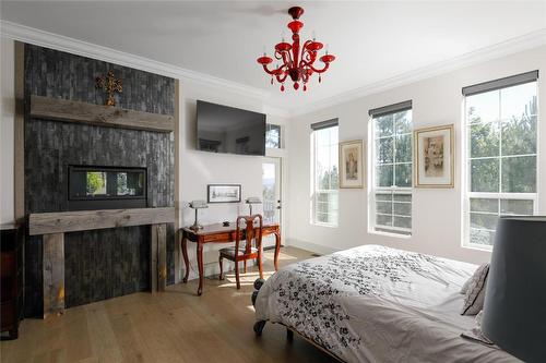 21-1150 Mission Ridge Road, Kelowna, BC - Indoor Photo Showing Bedroom With Fireplace