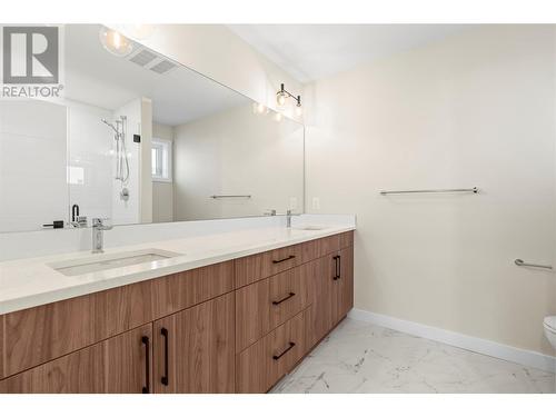 Ensiute has Double Sinks with Long Sleek Counter with Plenty of Storage - 3907 26 Street Unit# 1, Vernon, BC - Indoor Photo Showing Bathroom