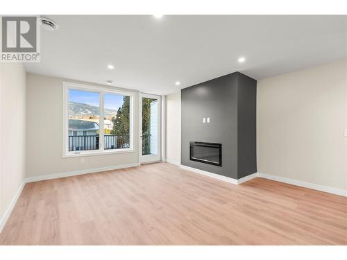 Living Area with Fireplace and Back Deck - 3907 26 Street Unit# 1, Vernon, BC - Indoor With Fireplace