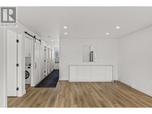 Gleaming vinyl plank flooring throughout - 3000 Richter Street Unit# 21, Kelowna, BC - Indoor Photo Showing Other Room