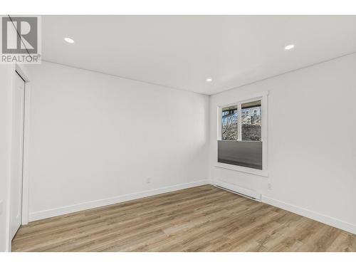 Bedroom 2 - good size w West exposure and  high end blind - 3000 Richter Street Unit# 21, Kelowna, BC - Indoor Photo Showing Other Room