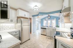 Kitchen with double sink, and breakfast nook with vaulted ceiling - 