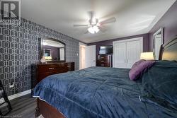 Primary bedroom with ceiling fan, and a closet - 