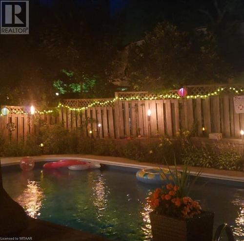 View of pool at night during the summer - 11 Golden Place, Ingersoll, ON - Outdoor With Body Of Water