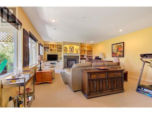 Family Room with large wall to wall windows and new blinds. - 580 Denali Drive, Kelowna, BC - Indoor With Fireplace