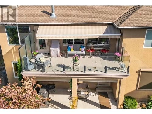 Upper deck with awning and lower deck. - 580 Denali Drive, Kelowna, BC - Outdoor With Exterior