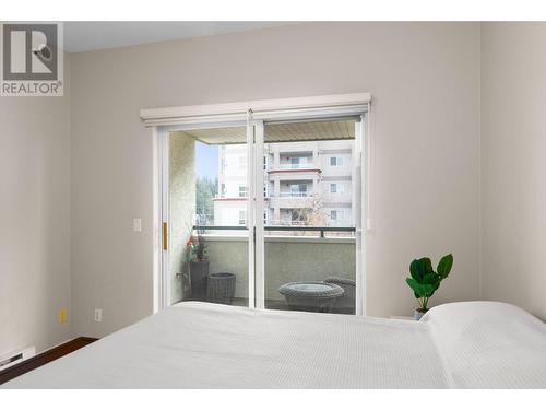 Sliding doors to the patio - 1950 Durnin Road Unit# 408, Kelowna, BC - Indoor Photo Showing Bedroom