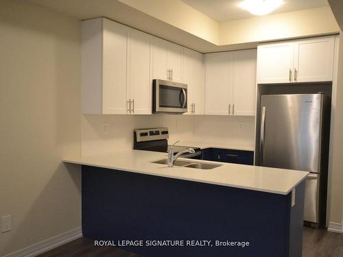 107-1573 Rose Way, Milton, ON - Indoor Photo Showing Kitchen With Stainless Steel Kitchen With Double Sink