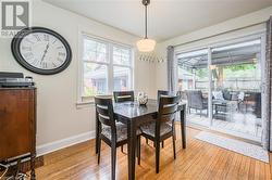 Dining room with light hardwood / wood-style floors and a wealth of natural light - 