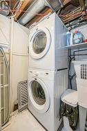 Laundry area featuring stacked washing maching and dryer - 