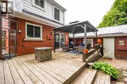 Wooden terrace featuring a gazebo and an outdoor living space - 