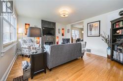 Living room featuring a tile fireplace and light hardwood / wood-style flooring - 