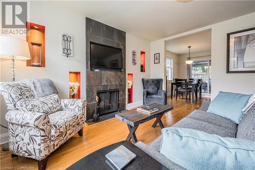 Living room featuring a tile fireplace and hardwood / wood-style flooring - 48 Dane Street, Kitchener, ON - Indoor Photo Showing Living Room With Fireplace