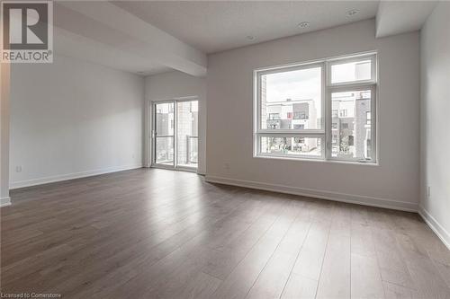 Empty room featuring hardwood / wood-style floors and beam ceiling - 1121 Cooke Boulevard Unit# 7, Burlington, ON - Indoor