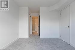 Unfurnished bedroom with light carpet and a closet - 