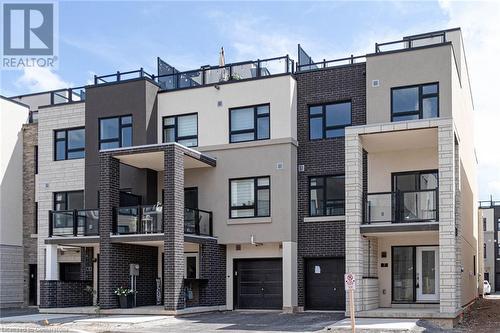 View of property featuring a garage - 1121 Cooke Boulevard Unit# 7, Burlington, ON - Outdoor With Balcony With Facade