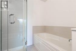 Bathroom featuring separate shower and tub and vanity - 