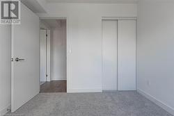 Unfurnished bedroom with elevator, a closet, and carpet - 