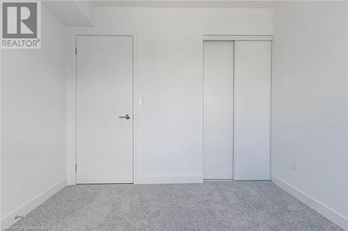 Unfurnished bedroom with carpet floors, elevator, and a closet - 1121 Cooke Boulevard Unit# 7, Burlington, ON - Indoor Photo Showing Other Room