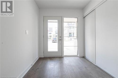 Doorway to outside featuring hardwood / wood-style floors and a healthy amount of sunlight - 1121 Cooke Boulevard Unit# 7, Burlington, ON - Indoor Photo Showing Other Room