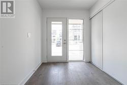 Doorway to outside featuring hardwood / wood-style floors and a healthy amount of sunlight - 