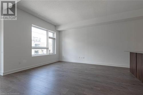 Unfurnished room with dark hardwood / wood-style floors and a textured ceiling - 1121 Cooke Boulevard Unit# 7, Burlington, ON - Indoor Photo Showing Other Room