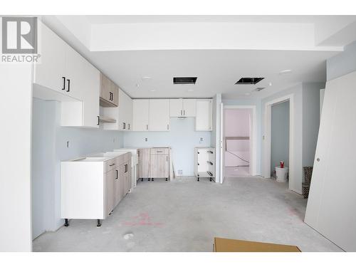 Photo from one of our larger 1 bedroom designs, which show cases the same colour scheme of Unit 101. Size and layout of kitchen may be different. - 215 Royal Avenue Unit# 101, Kamloops, BC - Indoor