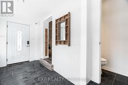 Entrance foyer - views to 2 piece bath/ living rm - 