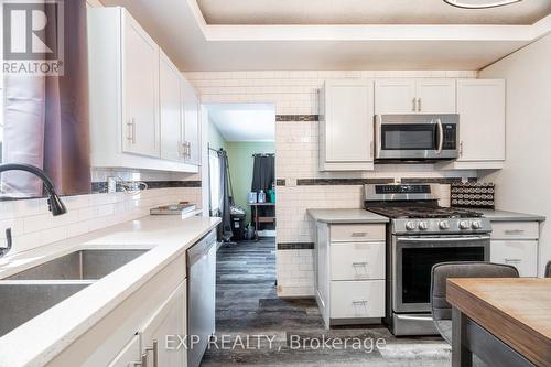 Kitchen w/ view into main flr laundry room add-on - 85 Dufferin Street, Stratford, ON - Indoor Photo Showing Kitchen