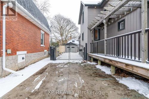 Stamped concrete driveway w/ gated back yard view - 85 Dufferin Street, Stratford, ON - Outdoor With Deck Patio Veranda With Exterior