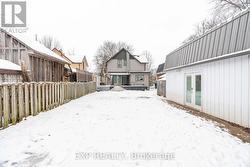 Photo of rear of yard - pool under snow - 