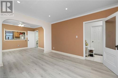 Unfurnished living room featuring a textured ceiling, ceiling fan, light hardwood / wood-style floors, and crown molding - 349 Kipling Avenue, Etobicoke, ON - Indoor Photo Showing Other Room